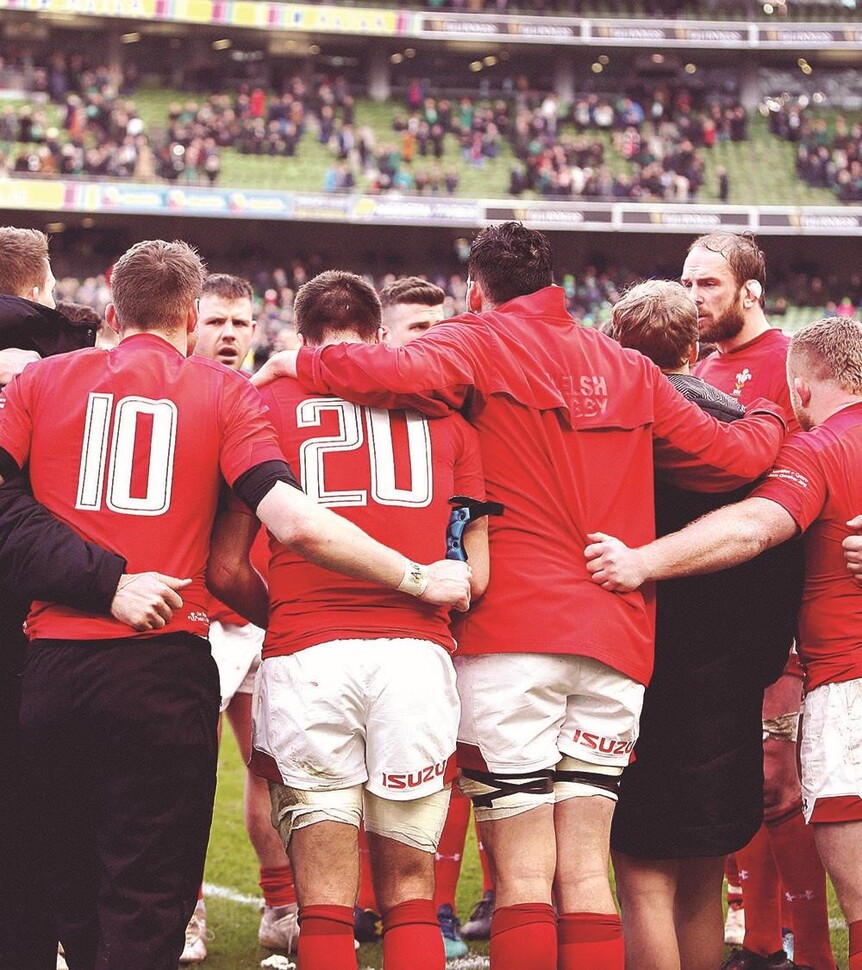 "Men's Welsh Rugby Union players hugging"