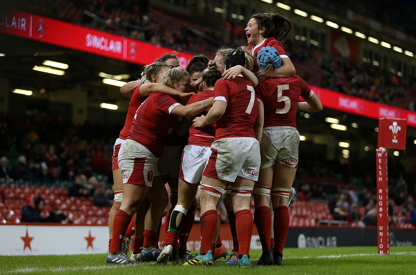 "Women's Welsh Rugby Union players hugging"
