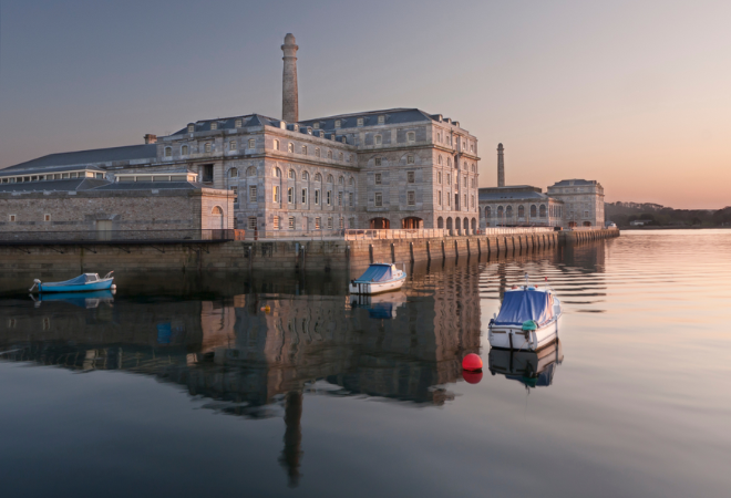 "Royal William at dusk as the sun sets in the right corner and the iconic building reflects into the water"