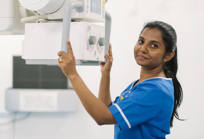 "A nurse with an x-ray machine"