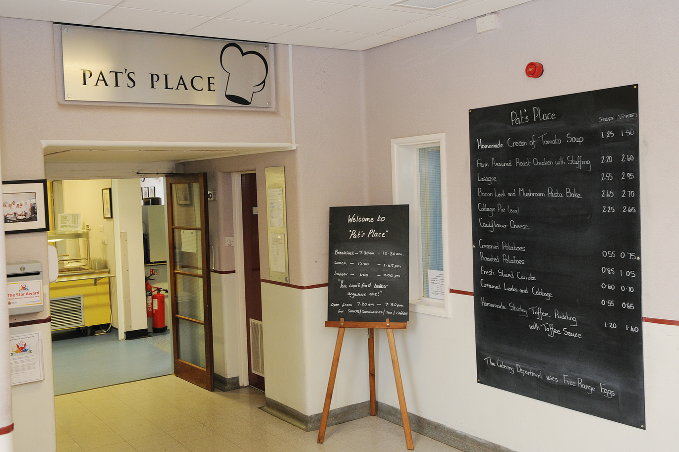 "Corridor in Scarborough Hospital with a menu and sign for Pat's Place café"