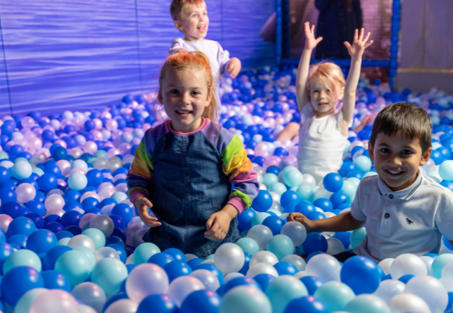 children playing in a ball pit