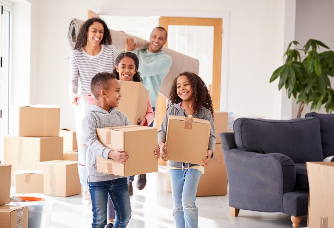 A family with three children moving in boxes