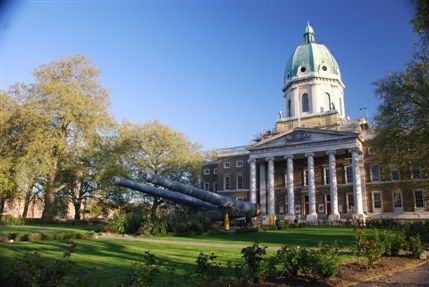 Photo of outside IWM London. The building has a dome like shape at the top and 6 pillars at the front.