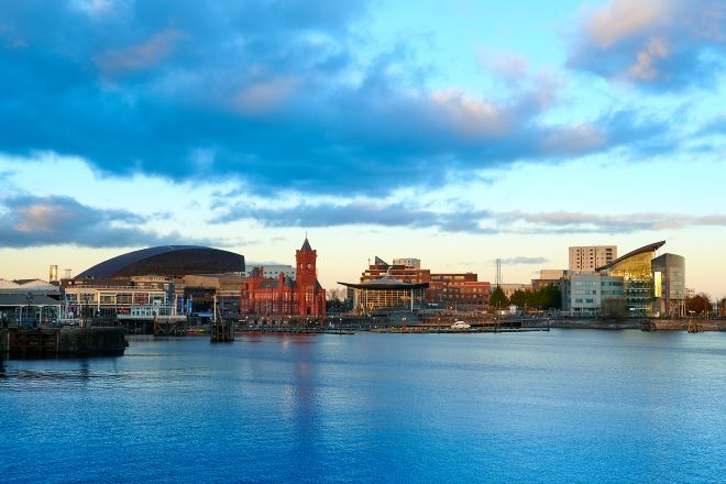 "Cardiff Bay at dawn, taken from over the water, looking at the shore"