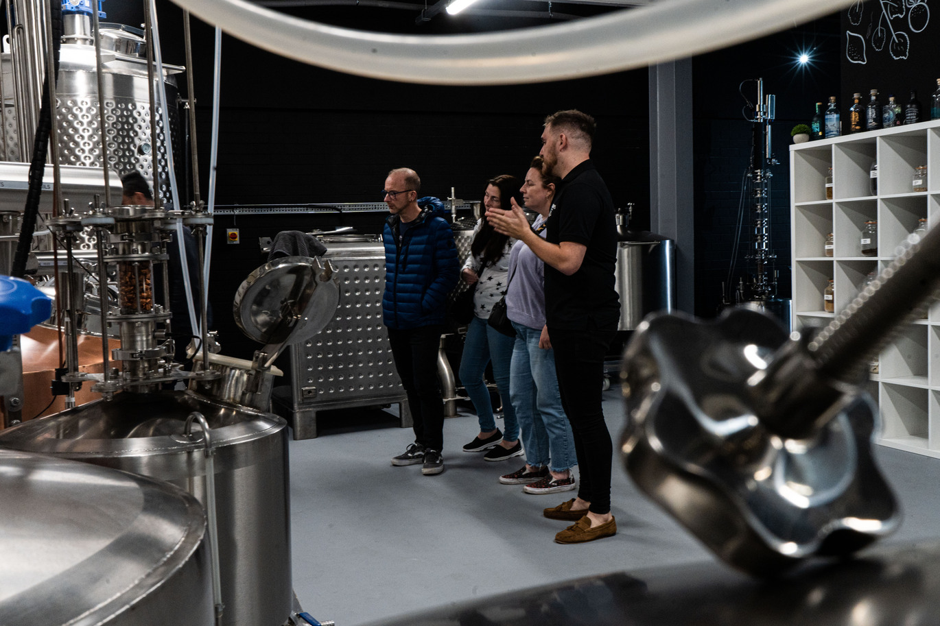 ''a group of people taking a tour of a brewery''