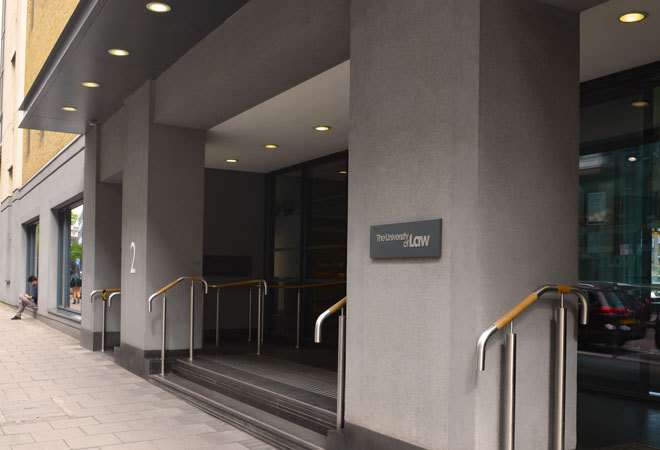 photo of the entrance to the university of law, moorgate campus. there are several steps and a ramp between grey columns.