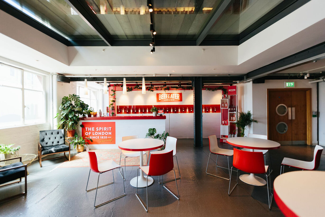 "Photograph of brightly lit bar area with tables and seating"