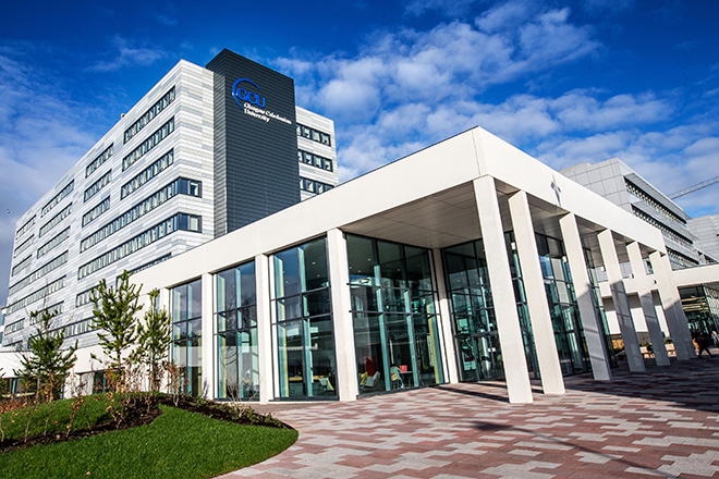 "Glasgow Caledonian University building entrance with paving in foreground and blue skies in background"