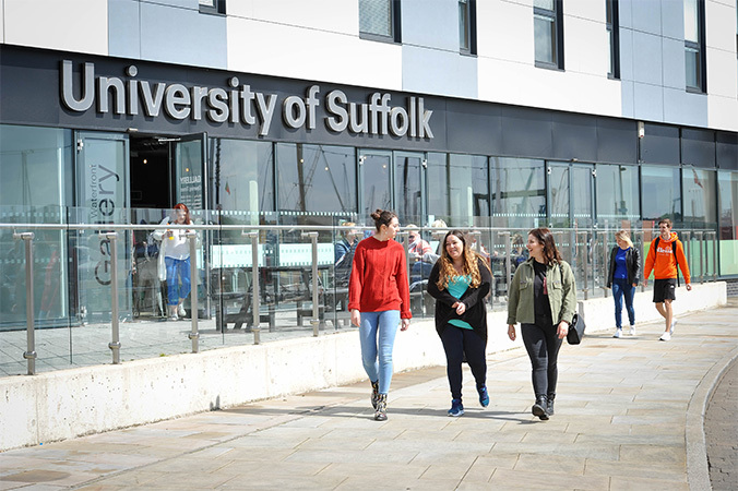 "photo of people walking past the University main entrance"