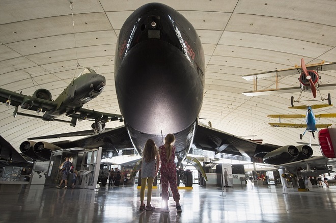 Photo of people looking up at plane
