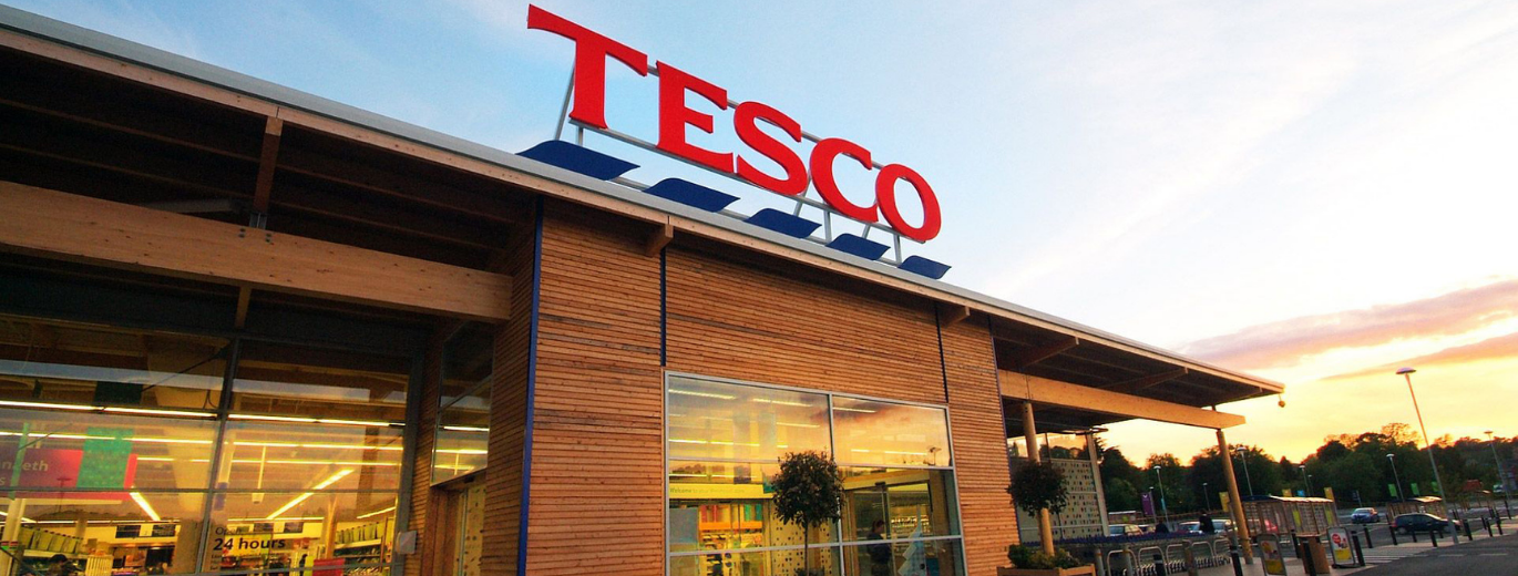 Tesco store front against blue sky