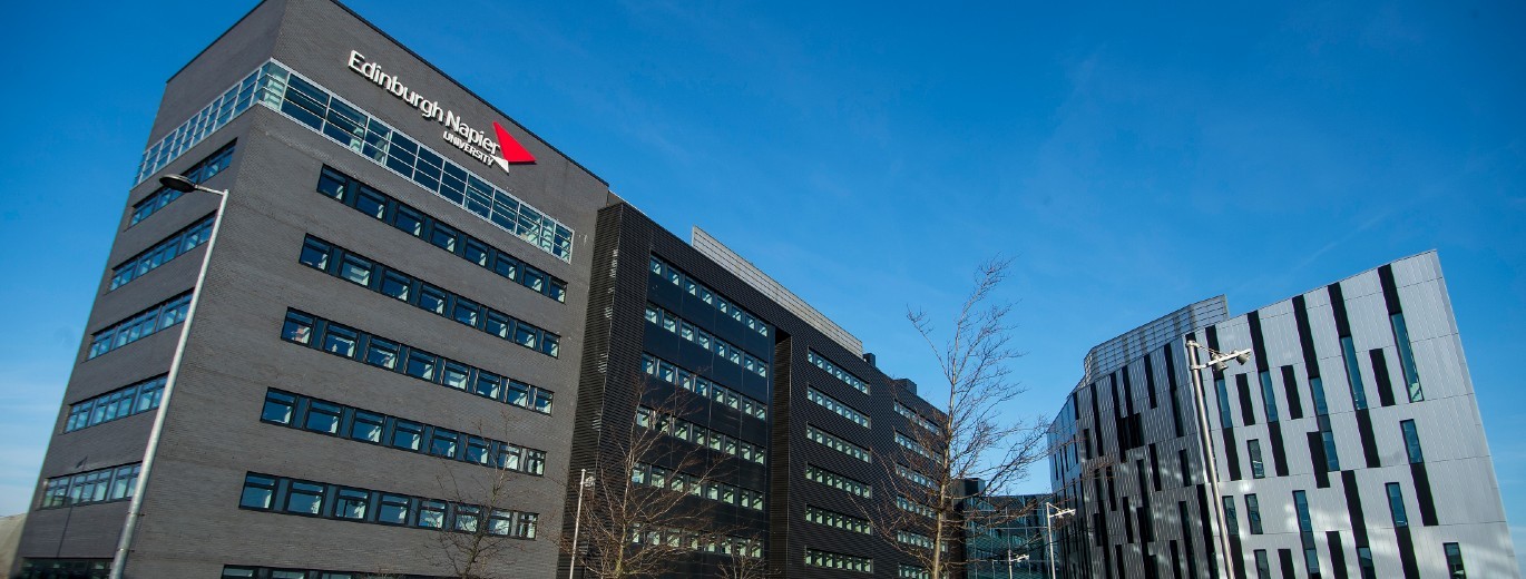 "Edinburgh Napier University building set against clear blue skies"