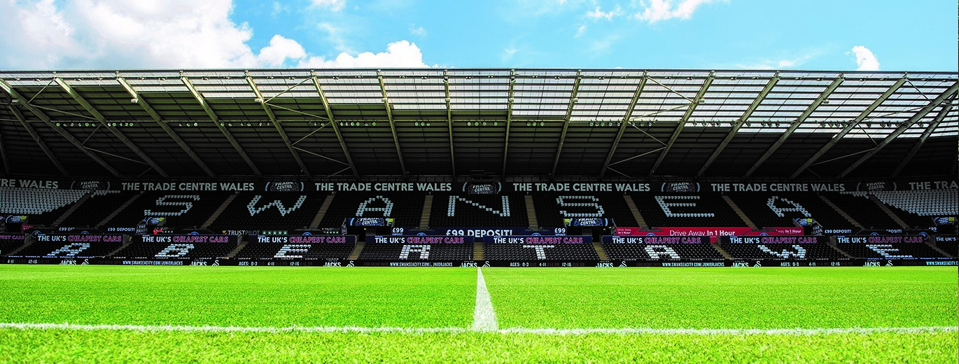 'Showing the stand inside the stadium with Swansea writing across the seating area'