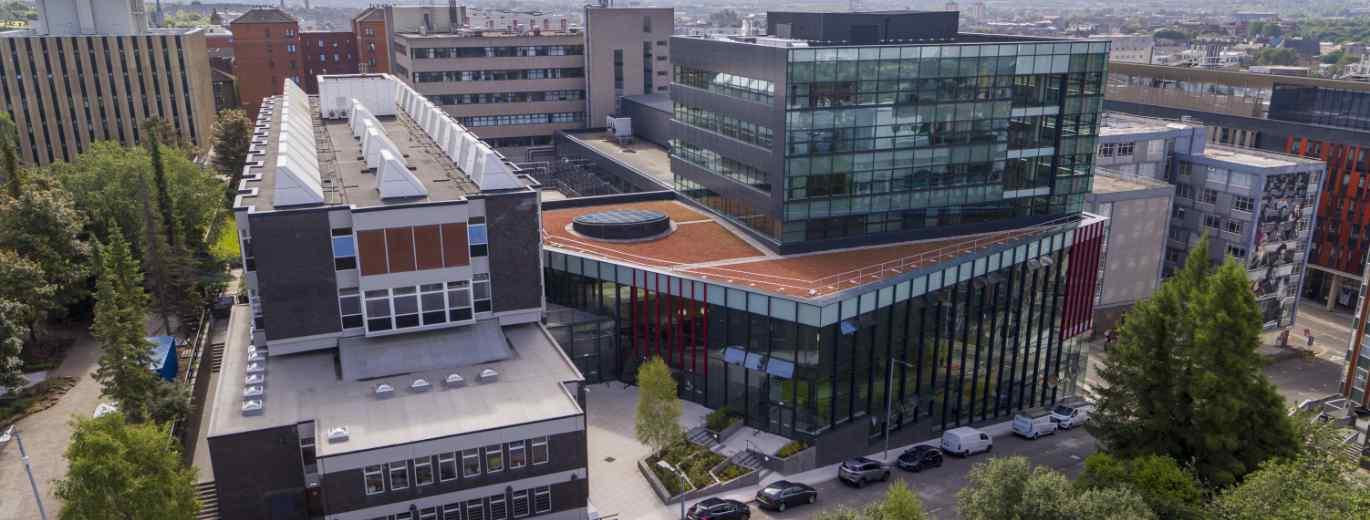 "Aerial view of the University of Strathclyde campus in Glasgow, showing modern glass-fronted buildings alongside older campus buildings"