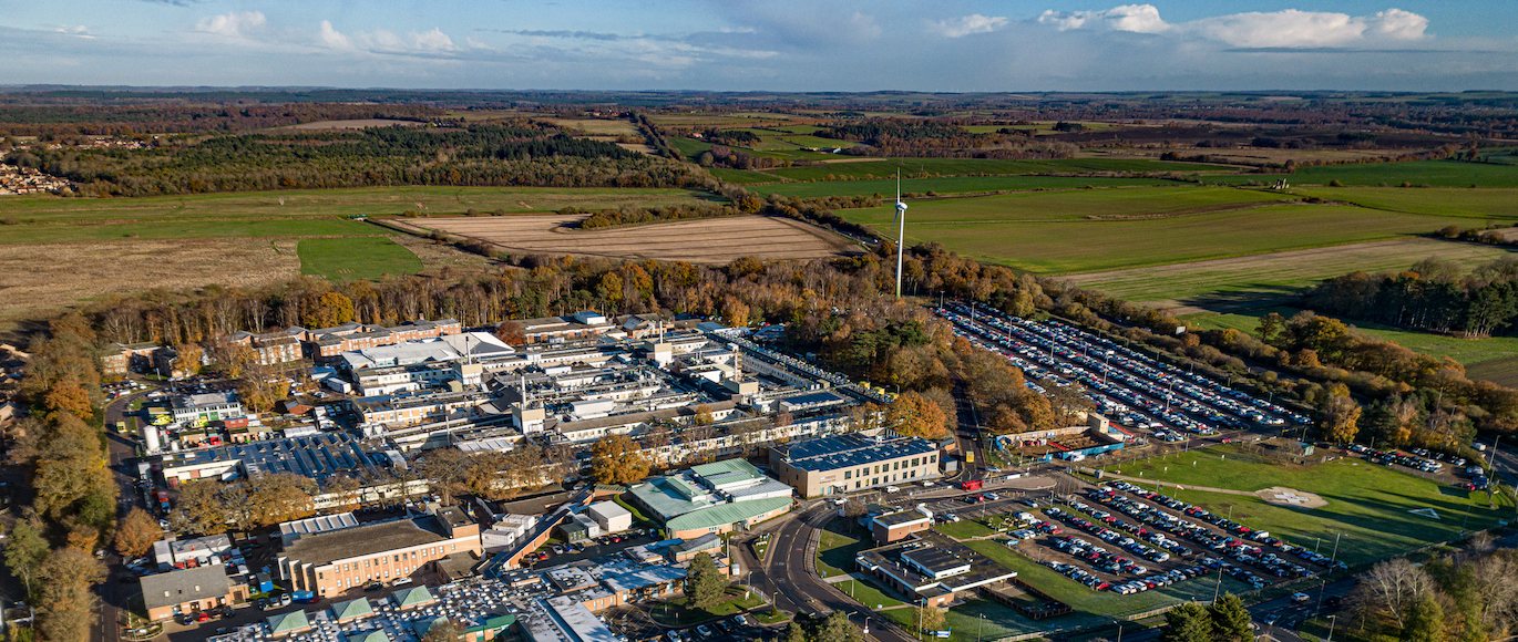 "Birds eye view of The Queen Elizabeth Hospital King's Lynn, green farming fields are in the background"
