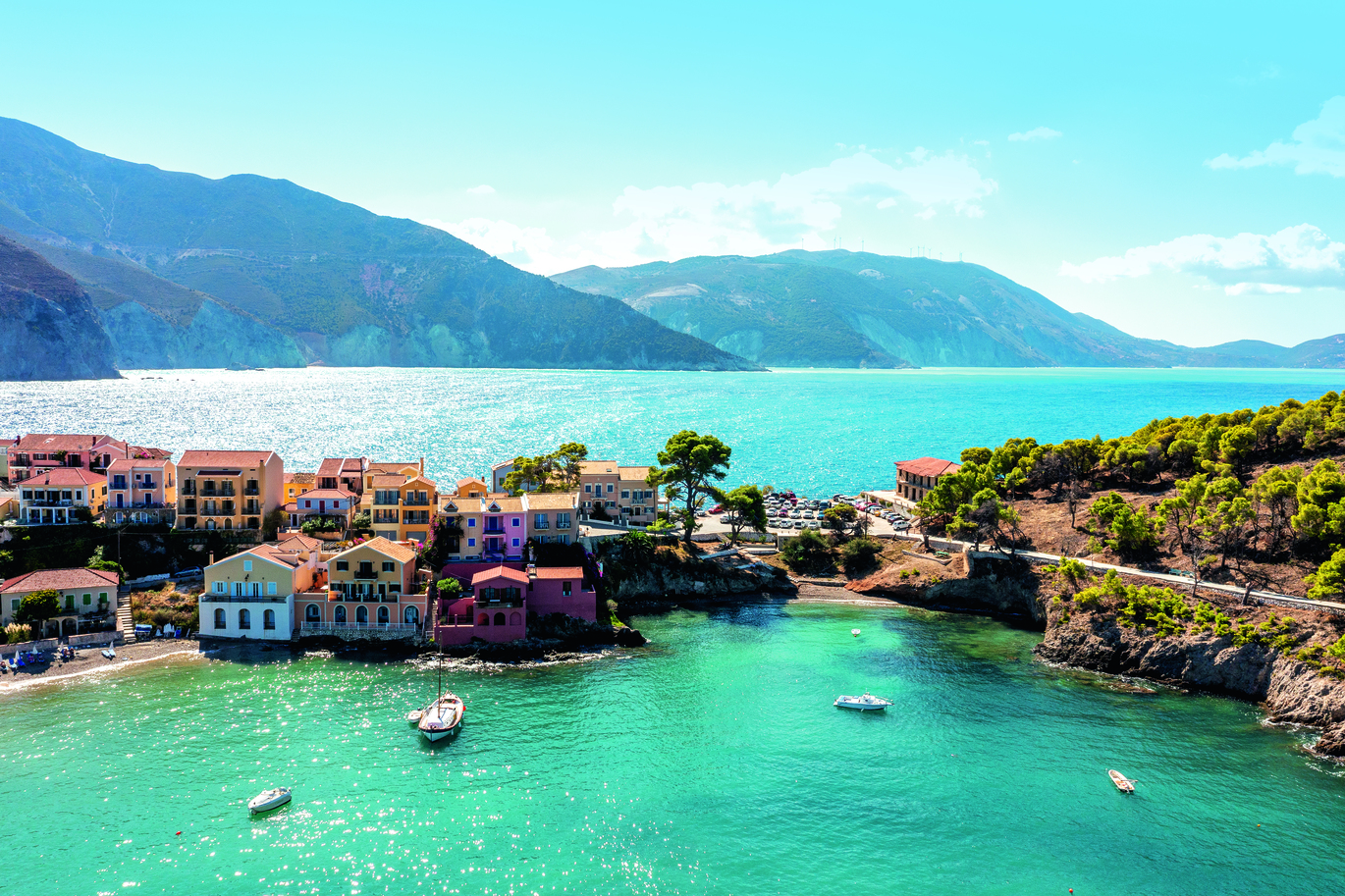 "Aerial shot of a coastline, blue green sea water, sand beach and bright sunshine, the Tui logo is visible in the image"