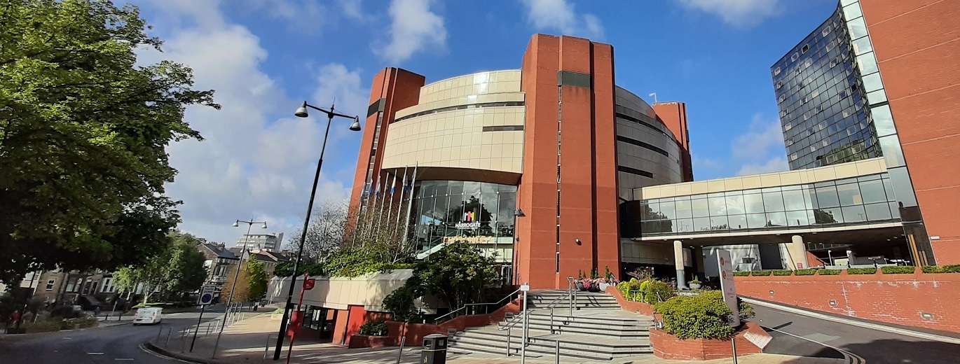 "Harrogate Convention Centre set against the backdrop of a blue sky"