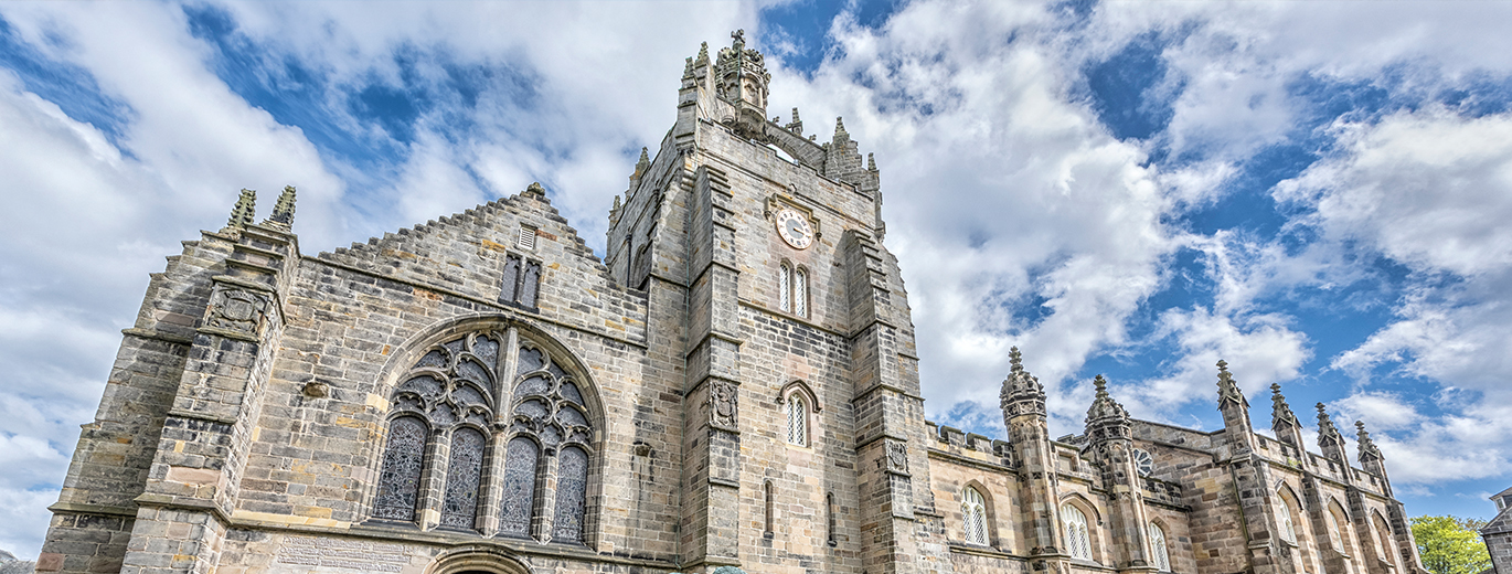 "University of Aberdeen building with blue and cloudy skies in background"