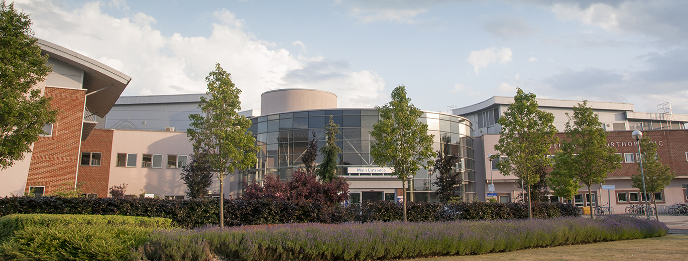 "Nuffield Orthopaedic Centre with trees and lavender in foreground"