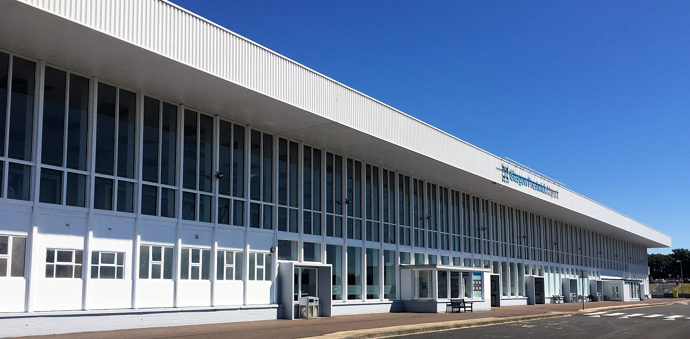 "Glasgow Prestwick Airport entrance with a zebra crossing in front of the building"