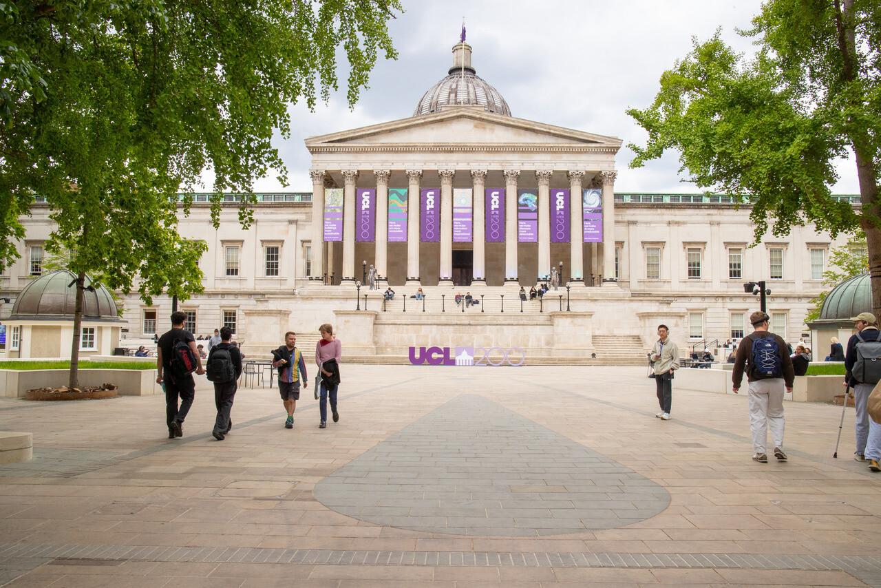 "Students walking and sitting in the UCL Main Quad"