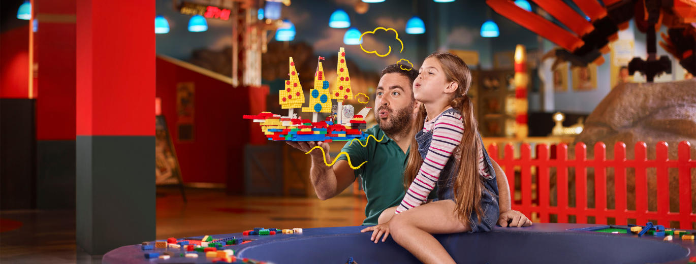 "Little girl and father with a lego pirate ship"