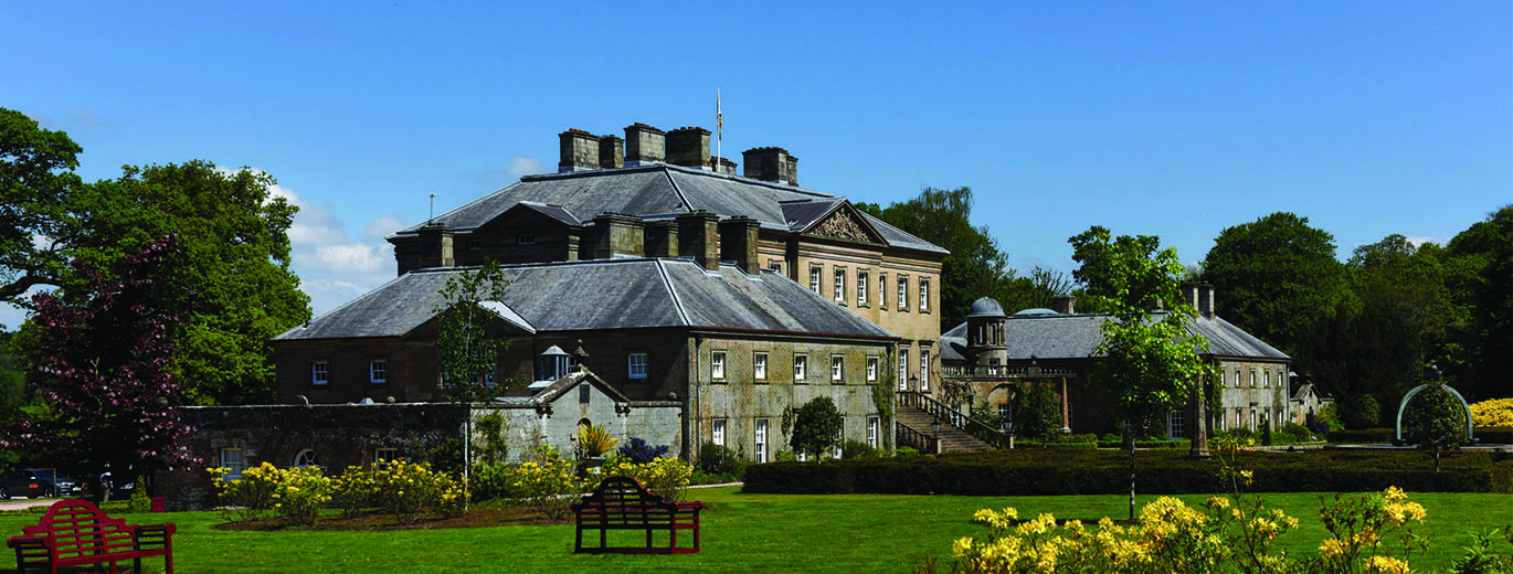 "Stately house in East Ayrshire set against clear blue skies"