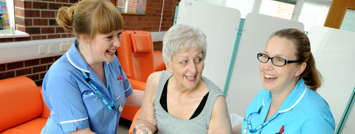 Photo of nurses consulting with patient