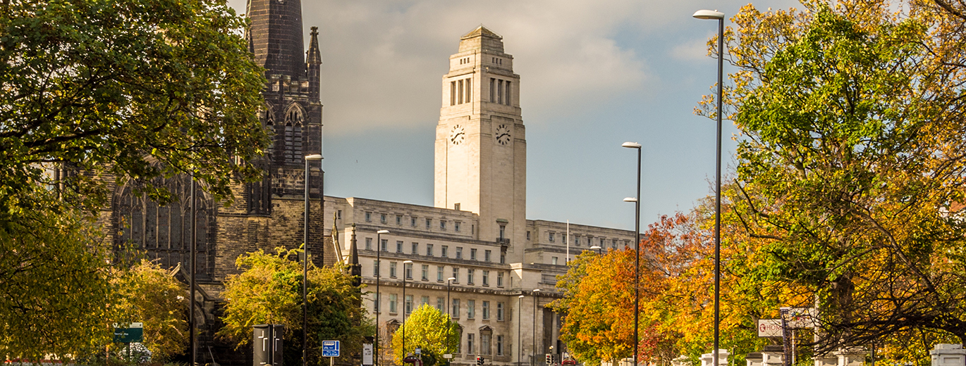 Photo of University of Leeds, with trees on either side of the road.