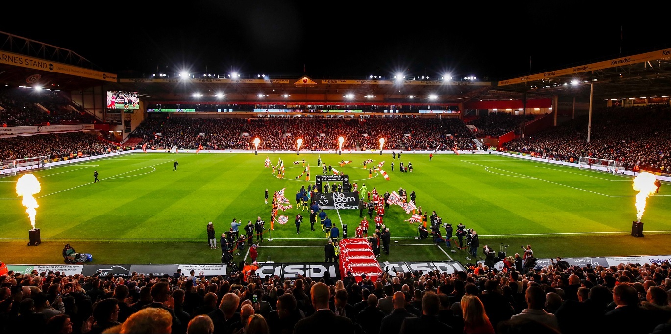 Photo of team coming out of tunnel at start of an evening match