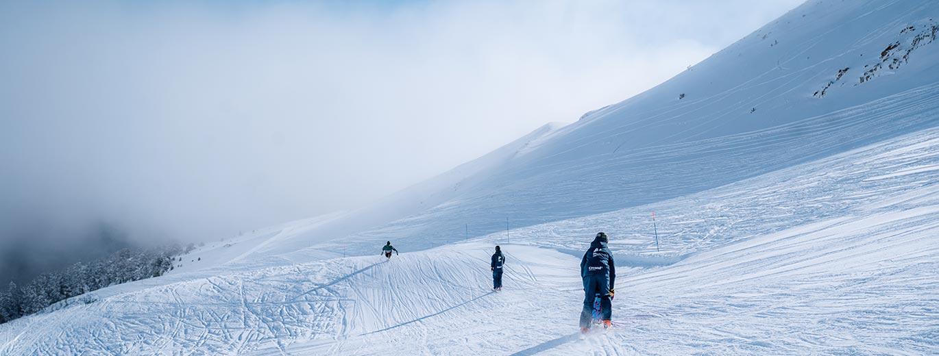 Perfect conditions for Skiing, 3 people on the slopes enjoying the blue run
