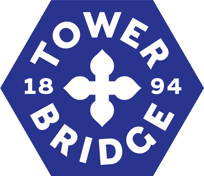 "Blue hexagon with white writing inside saying Tower Bridge 1894"