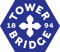 "Blue hexagon with white writing inside saying Tower Bridge 1894"