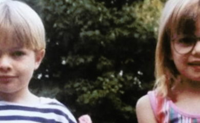 Natalie is pictured on the right side of the image. She is around 6 or 7 in the photo, wears glasses and is smiling at the camera. Her brother sits next to her at around 4 to 4 years old and is also smiling at the camera. Both children are white with blonde hairi.