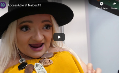 Sam Renke wearing a yellow dress and a black hat