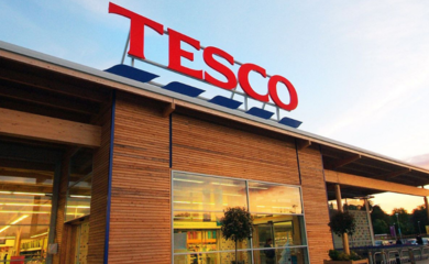 Tesco store front against blue sky