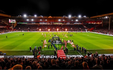 Football players on pitch at stadium