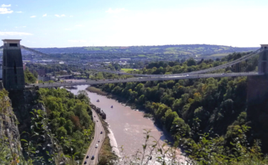 Image of Clifton Suspension Bridge, Bristol over the river. There is greenery around the bridge and at the forefront of the image.