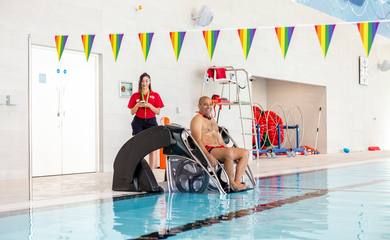 Image of a female and male on poolside.