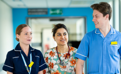 Image of 3 healthcare professionals walking down a corridor