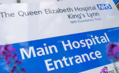 Image of a sign which says Queen Elizabeths Hospital Kings Lynn NHS Foundation Trust and Main Hospital Entrance